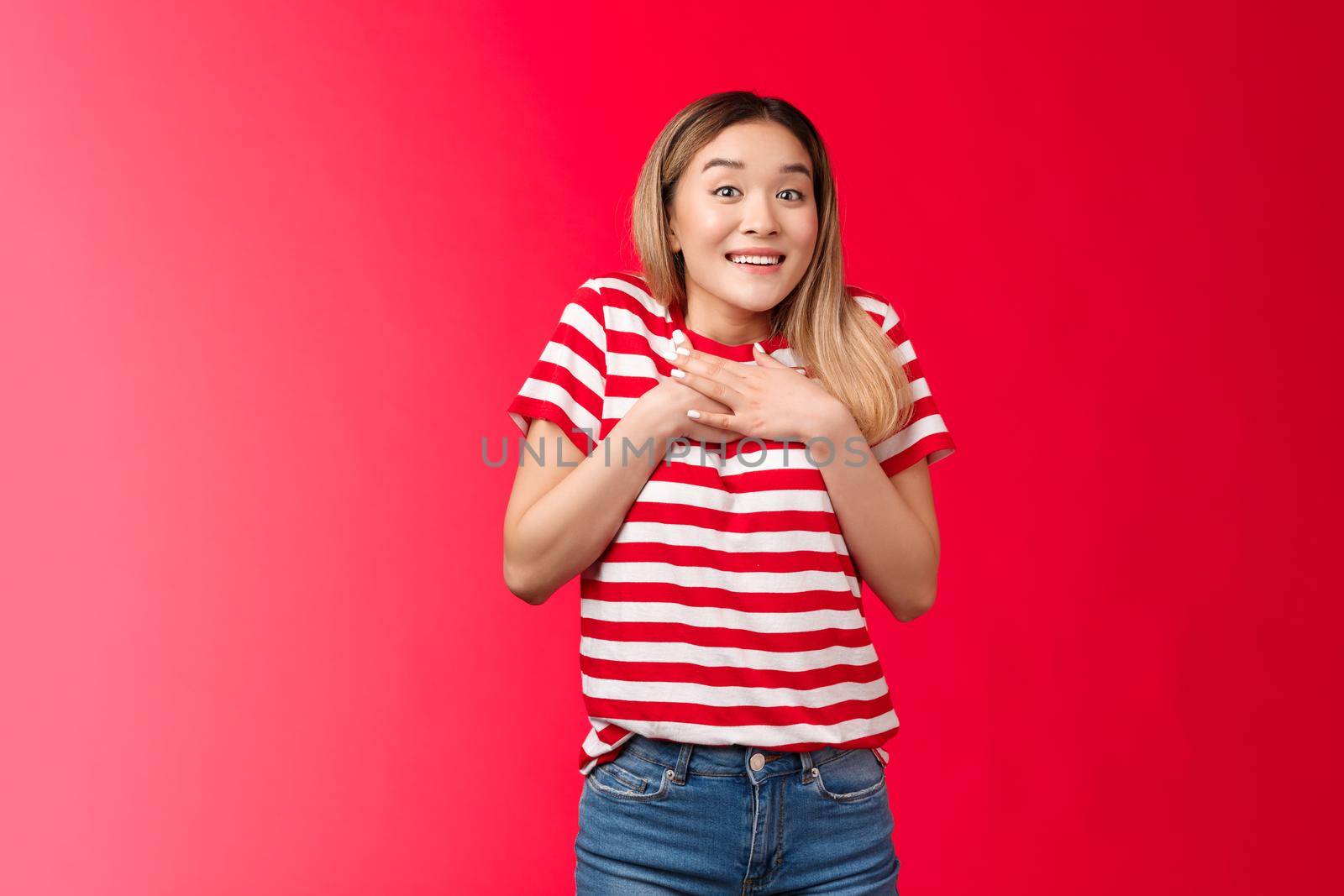 Impressed tender asian silly blond girl amazed describe fascinating performance, woman press palms chest smiling speechless adore cool gift, feed grateful and appreciation, stand red background.