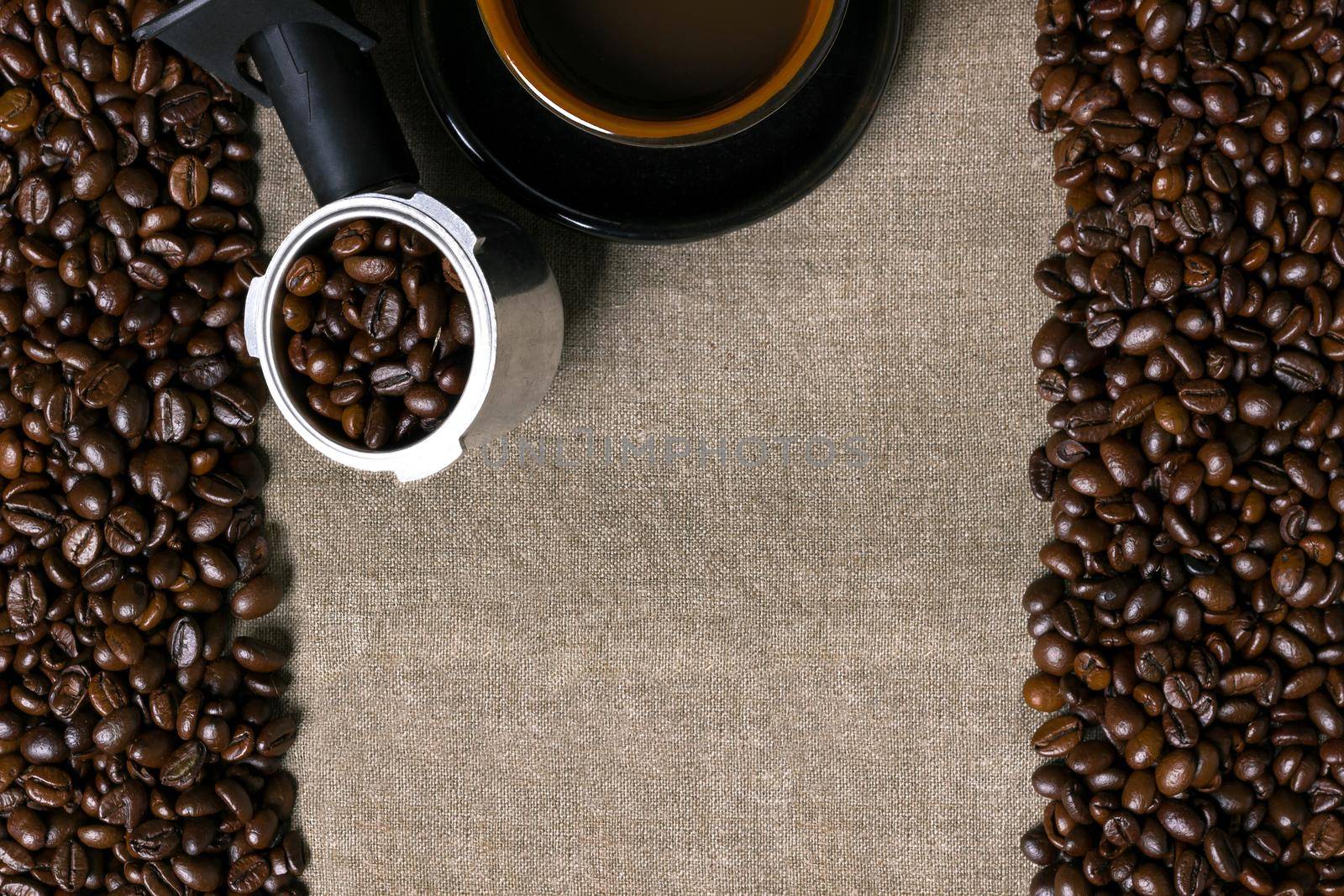 Coffee beans and Coffee cup on a burlap background. Top view. Copy space. Still life. Mock-up. Flat lay