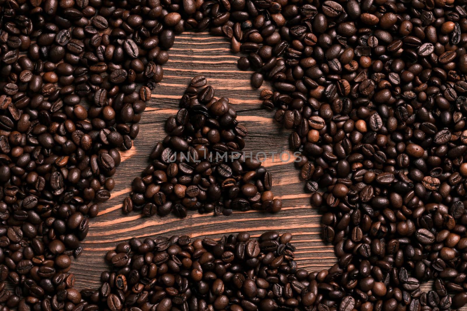 Letter A inscription with coffee bean on the wooden table by nazarovsergey