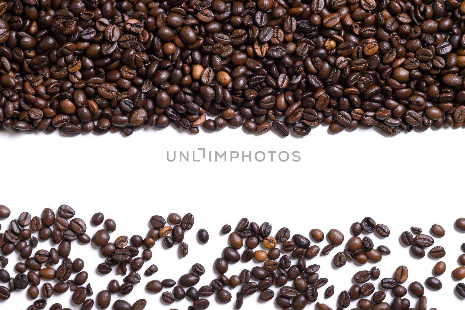 White background with coffee beans on the side. Top view. Still life. Copy space. Flat lay.