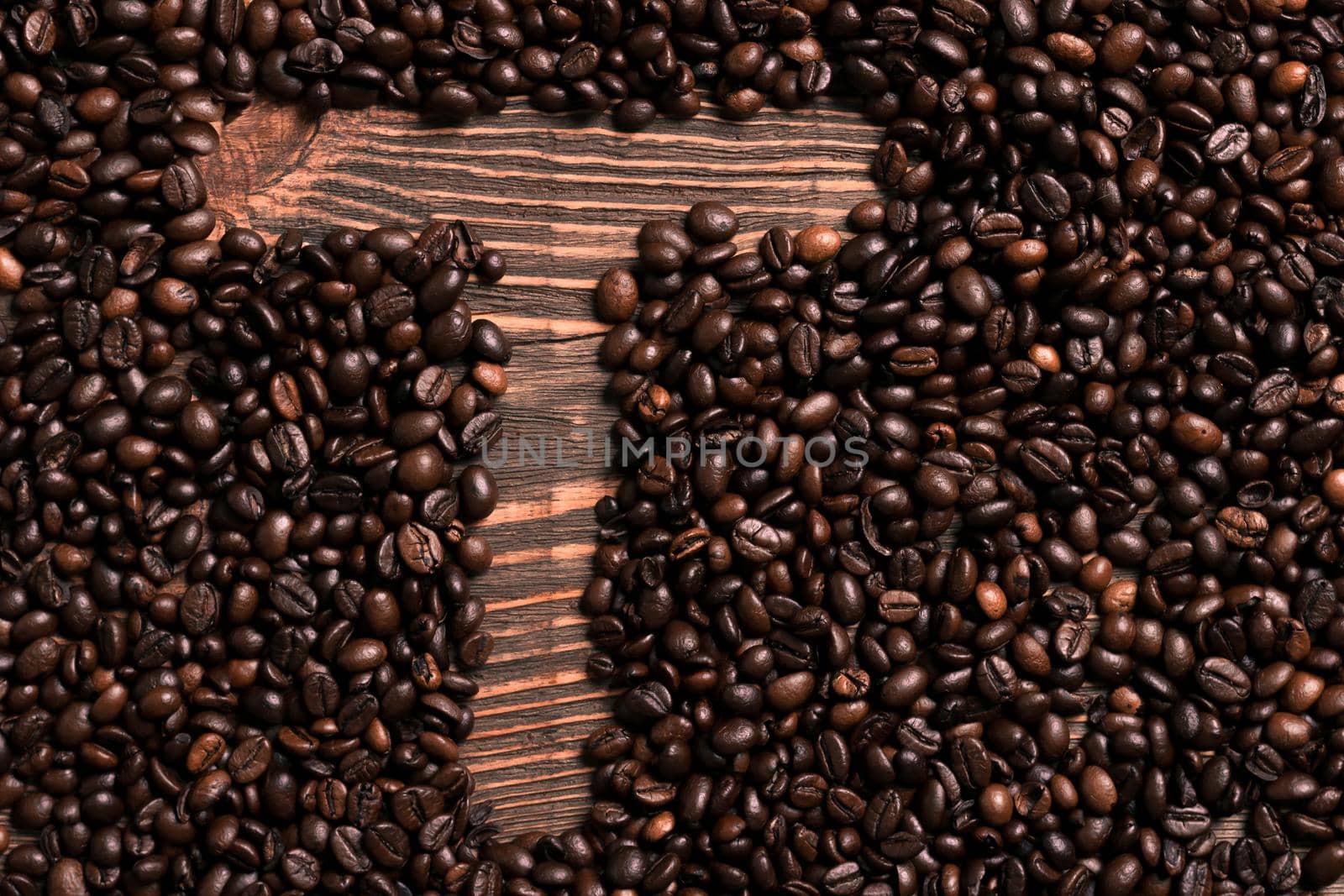 Letter T inscription with coffee bean on the wooden table. Top view. Copy space. Still life. Mock-up. Flat lay