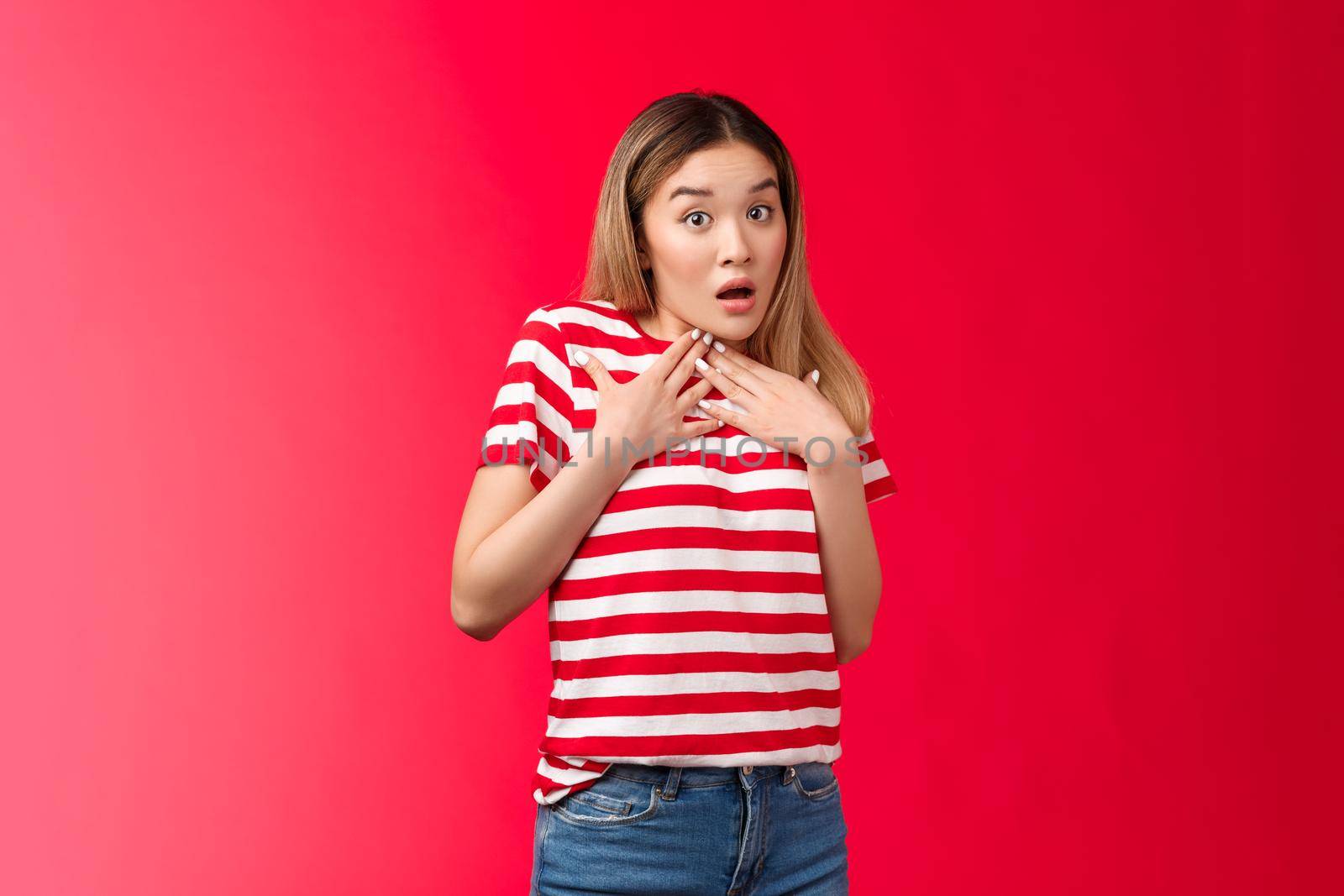 Shocked speechless glamour blond asian girl press palm chest astonished surprised gasping shook open mouth wondered raise eyebrows innocent amazed, hear gossips stand red background by Benzoix