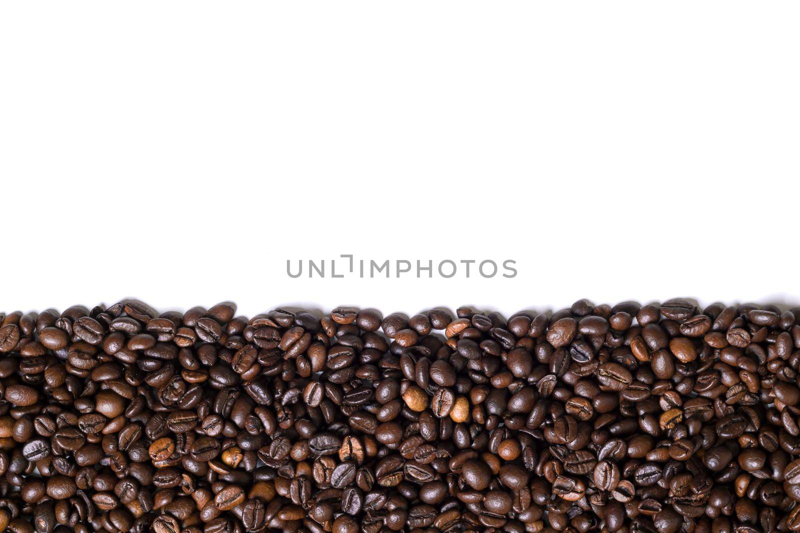 White background with coffee beans on the side. View from above with space for text. Still life. Mock-up. Flat lay