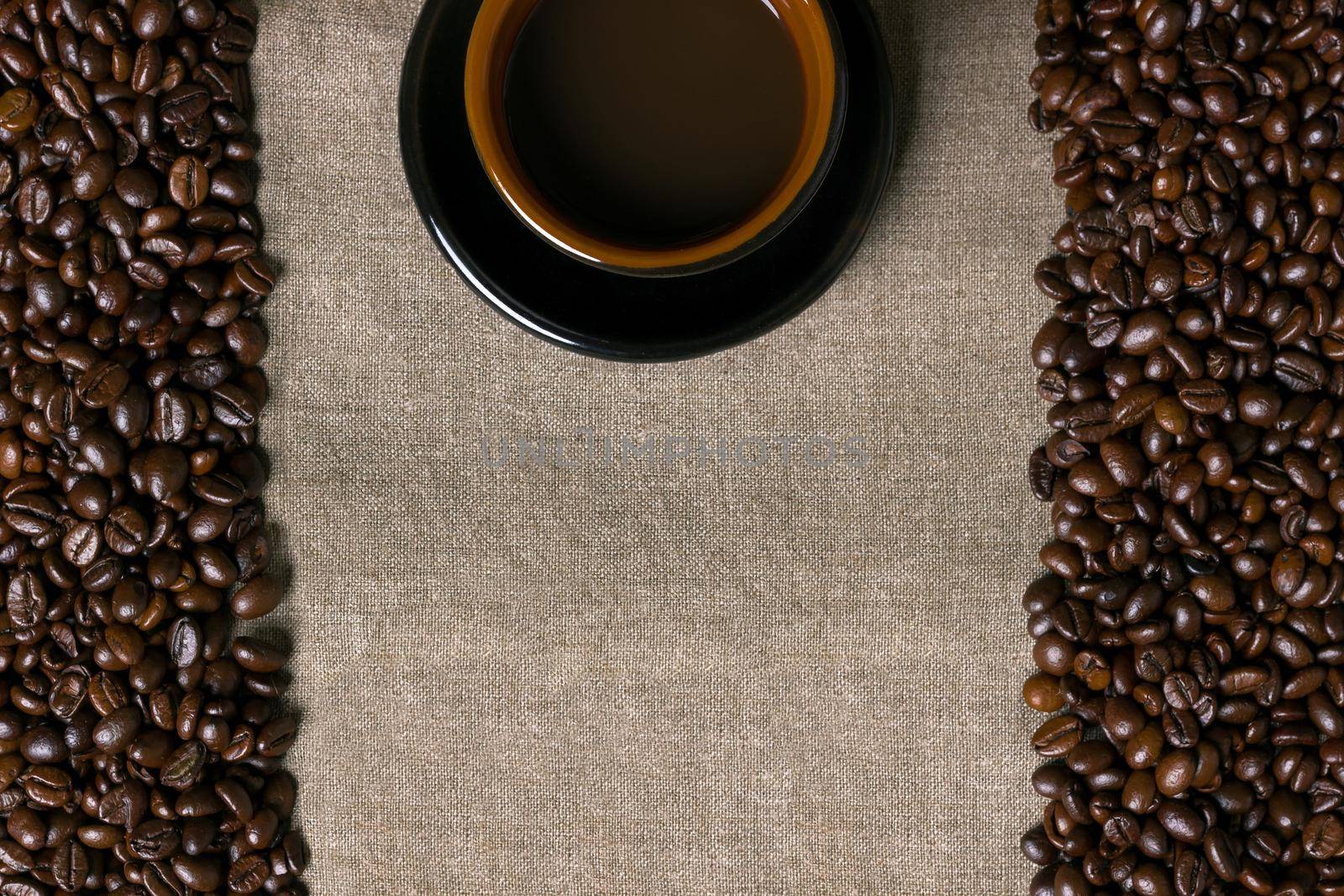 Coffee beans and Coffee cup on a burlap background by nazarovsergey