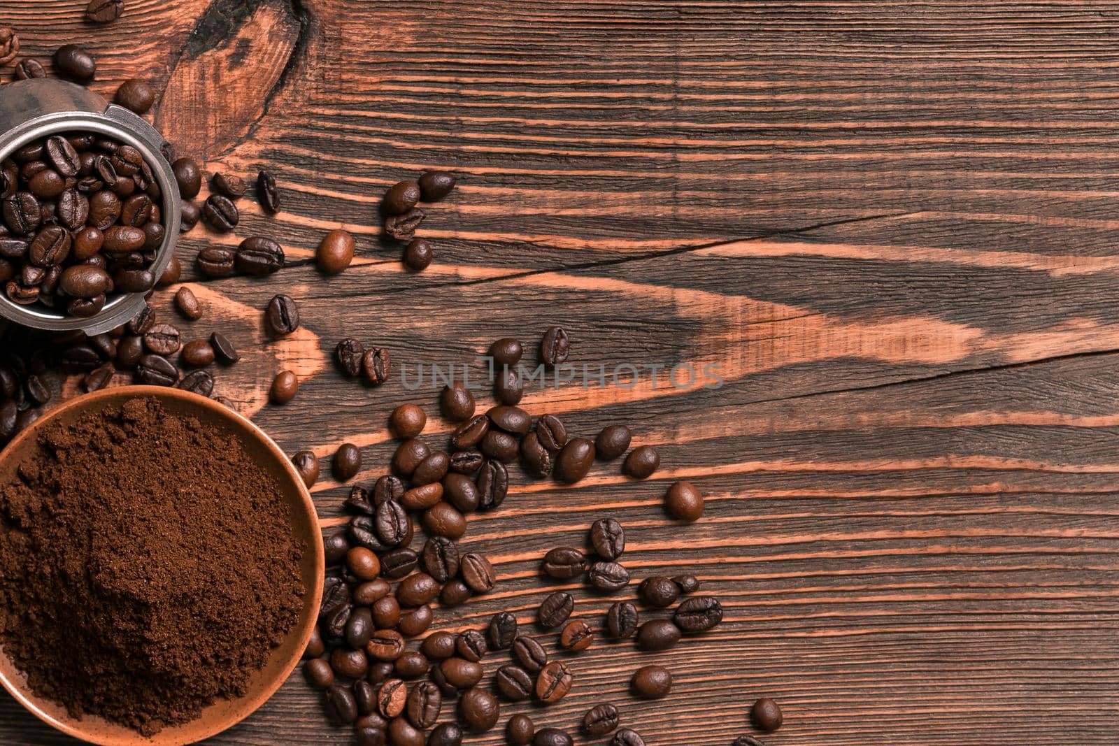 Coffee beans and ground coffee on rustic wooden table, view from above with space for text. Still life. Mock-up. Flat lay