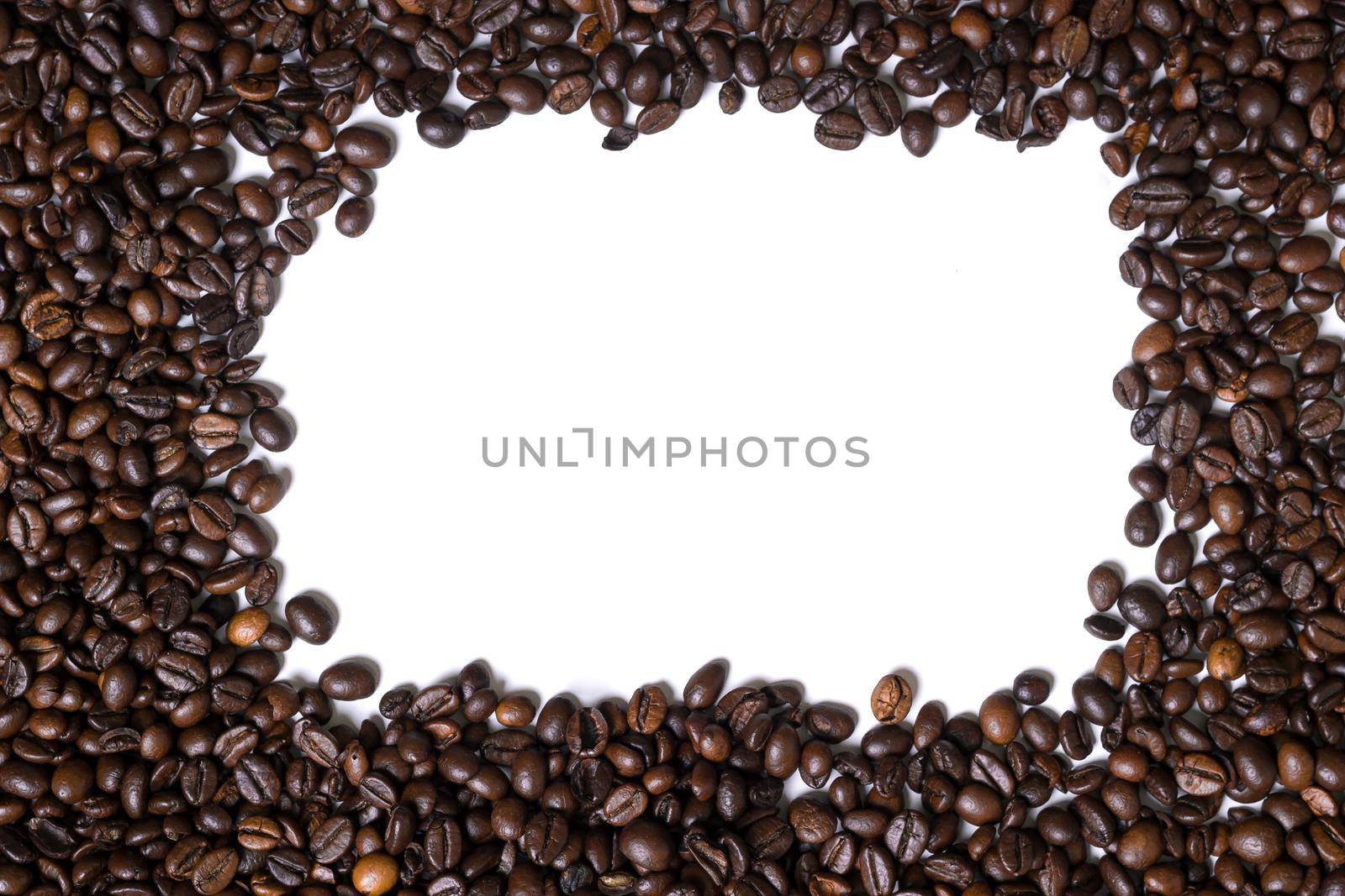 White background with coffee beans on four side. View from above with space for text. Still life. Mock-up. Flat lay