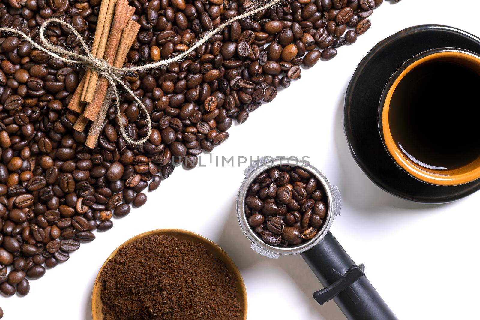 Cup of coffe, grains of coffee, ground coffee and cinnamon on a white background. Top view. Still life. Copy space. Flat lay.