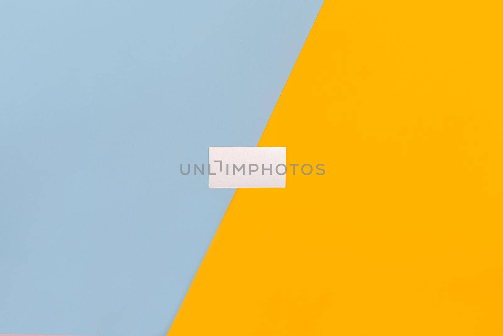 Business card blank over colorful abstract background. Top view. Copy space. Still life. Mock-up. Flat lay