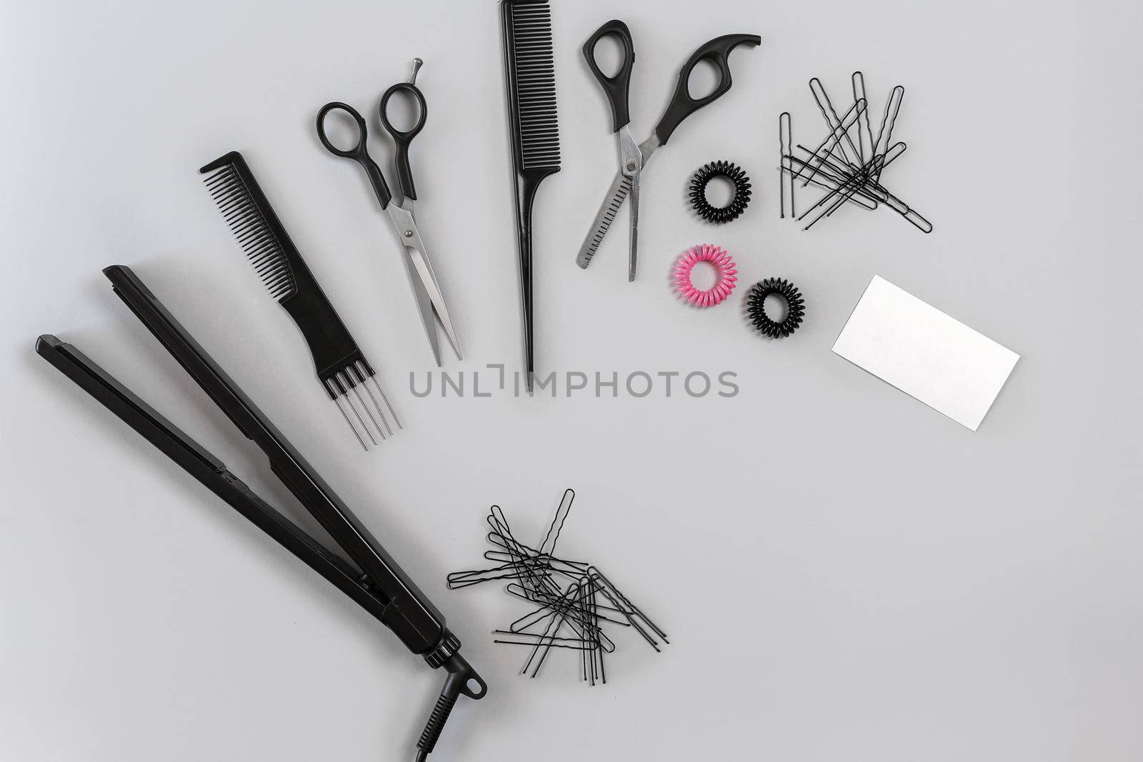 Hairdresser set with various accessories on gray background. Top view. Still life. Flat lay.