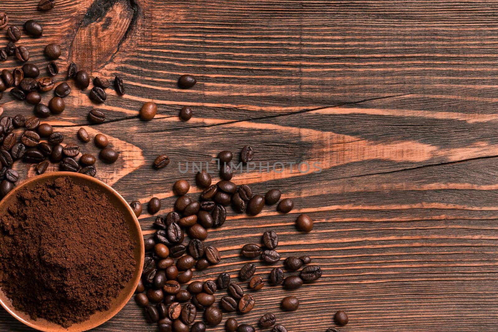 Coffee beans and ground coffee on rustic wooden table, view from by nazarovsergey