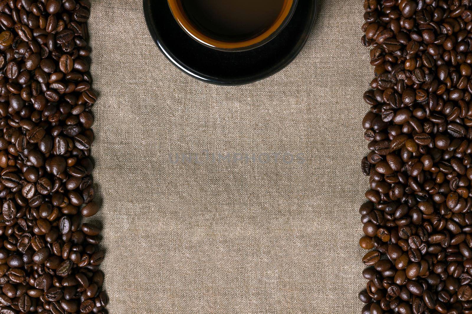 Coffee beans and Coffee cup on a burlap background by nazarovsergey