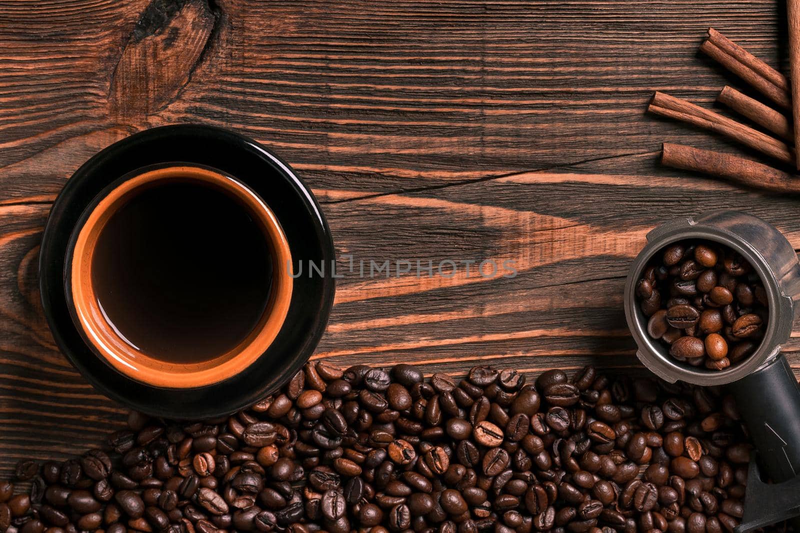 Coffee cup and beans frame on wooden table. Top view. Copy space. Still life. Mock-up. Flat lay