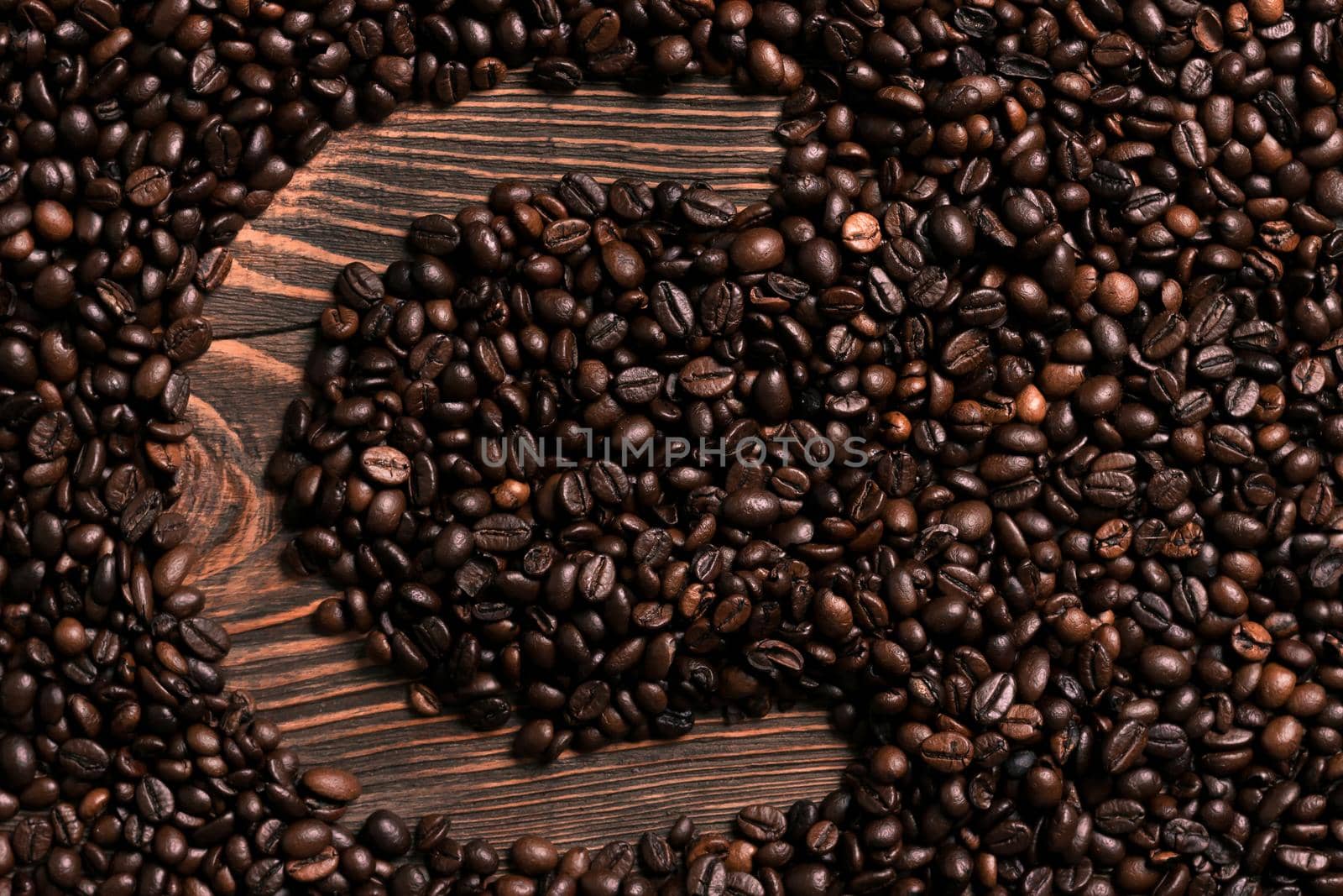 Letter C inscription with coffee bean on the wooden table by nazarovsergey