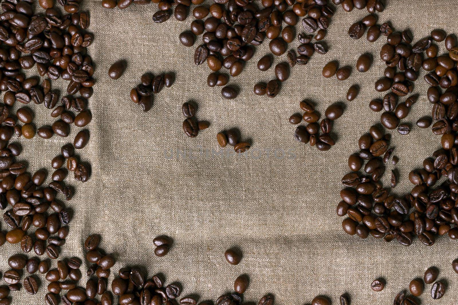 Coffee beans on burlap background. Top view. Copy space. Still life. Mock-up. Flat lay