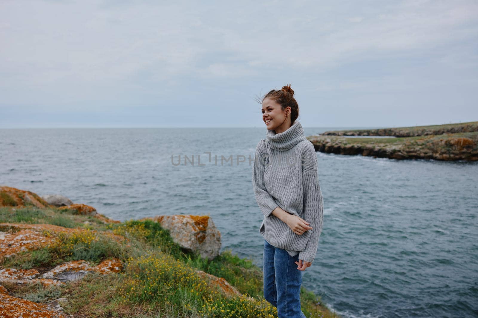 portrait of a woman sweaters cloudy sea admiring nature Lifestyle. High quality photo