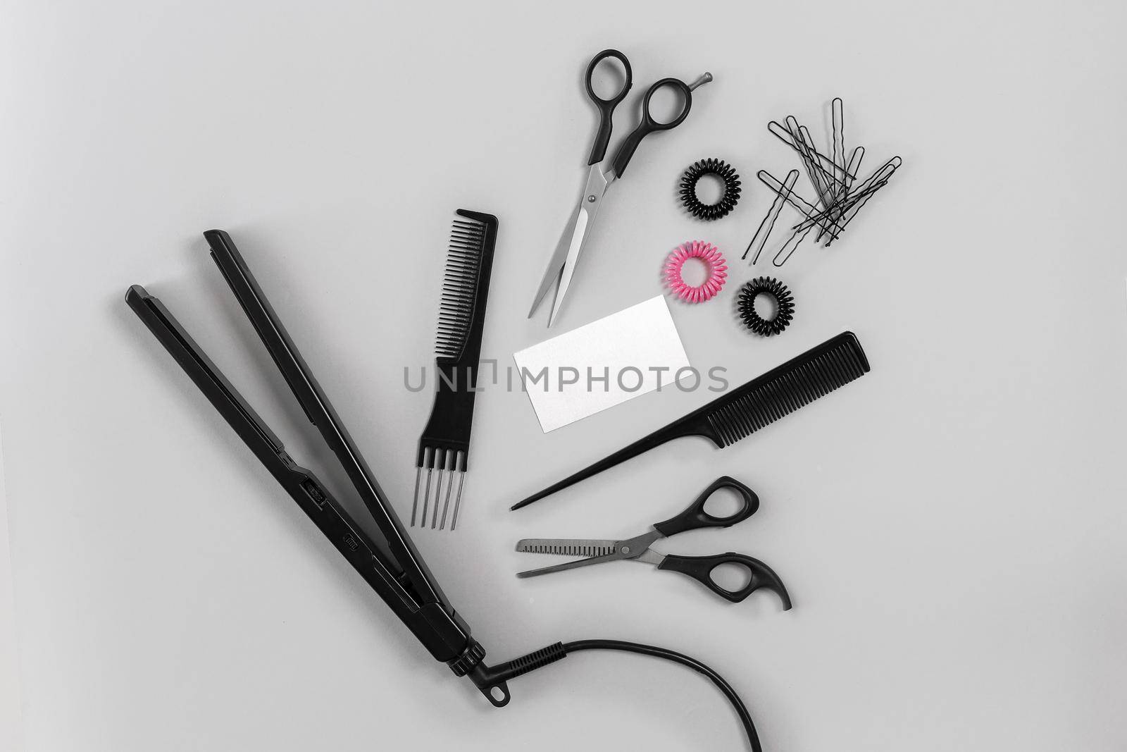 Hairdresser set with various accessories on gray background. Top view. Still life. Flat lay.