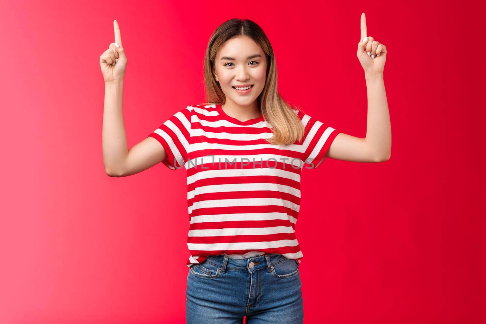 Hey up we go. Cheerful good-looking young asian girl pointing hands up, showing promotion smiling cheerful, female model propose good place hang advertisement, standing red background by Benzoix