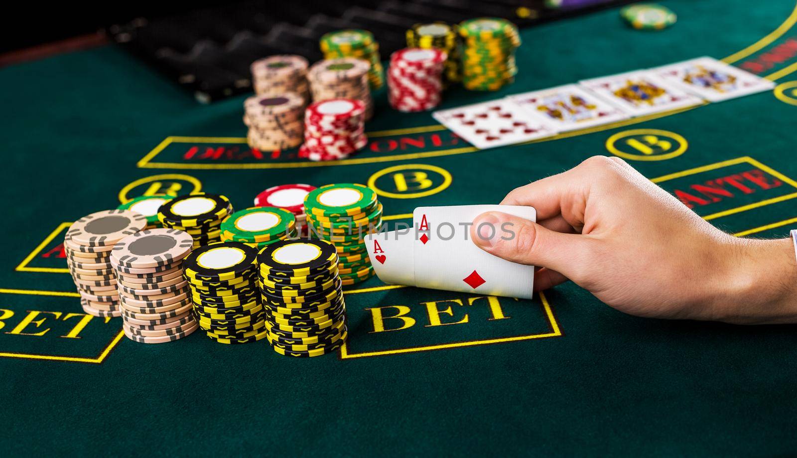 Male poker player lifting the corners of two cards aces by nazarovsergey