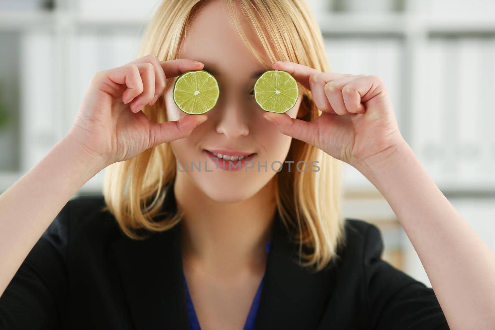 Portrait of girl hold cut fruit at eye level instead of glasses. Healthy diet, choose healthy lifestyle and add vitaminized nutrition. Kitchen, eat concept