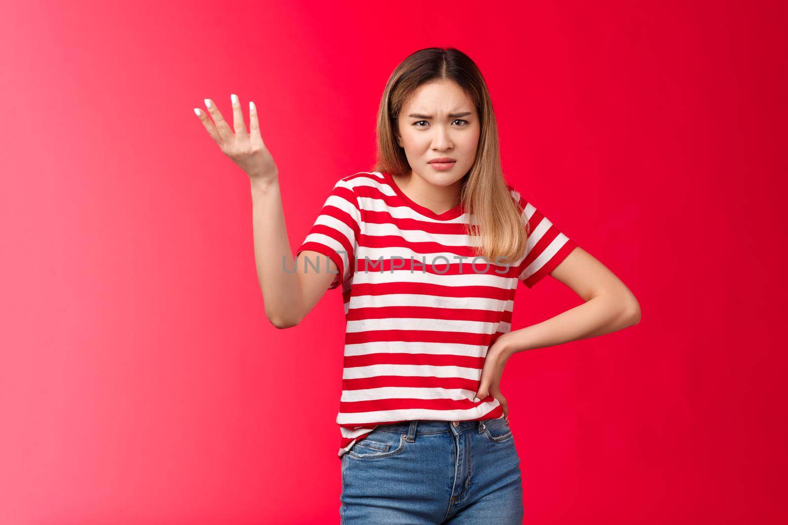 Wtf nonsense. Pissed unsatisfied female customer complain unaccepatable behaviour raise hand dismay frowning arguing, look questioned disappointed, annoyed strange situation, red background.