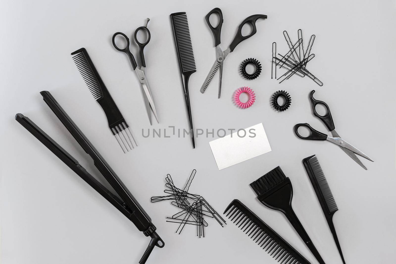 Hairdresser set with various accessories on gray background. Top view. Still life. Flat lay.