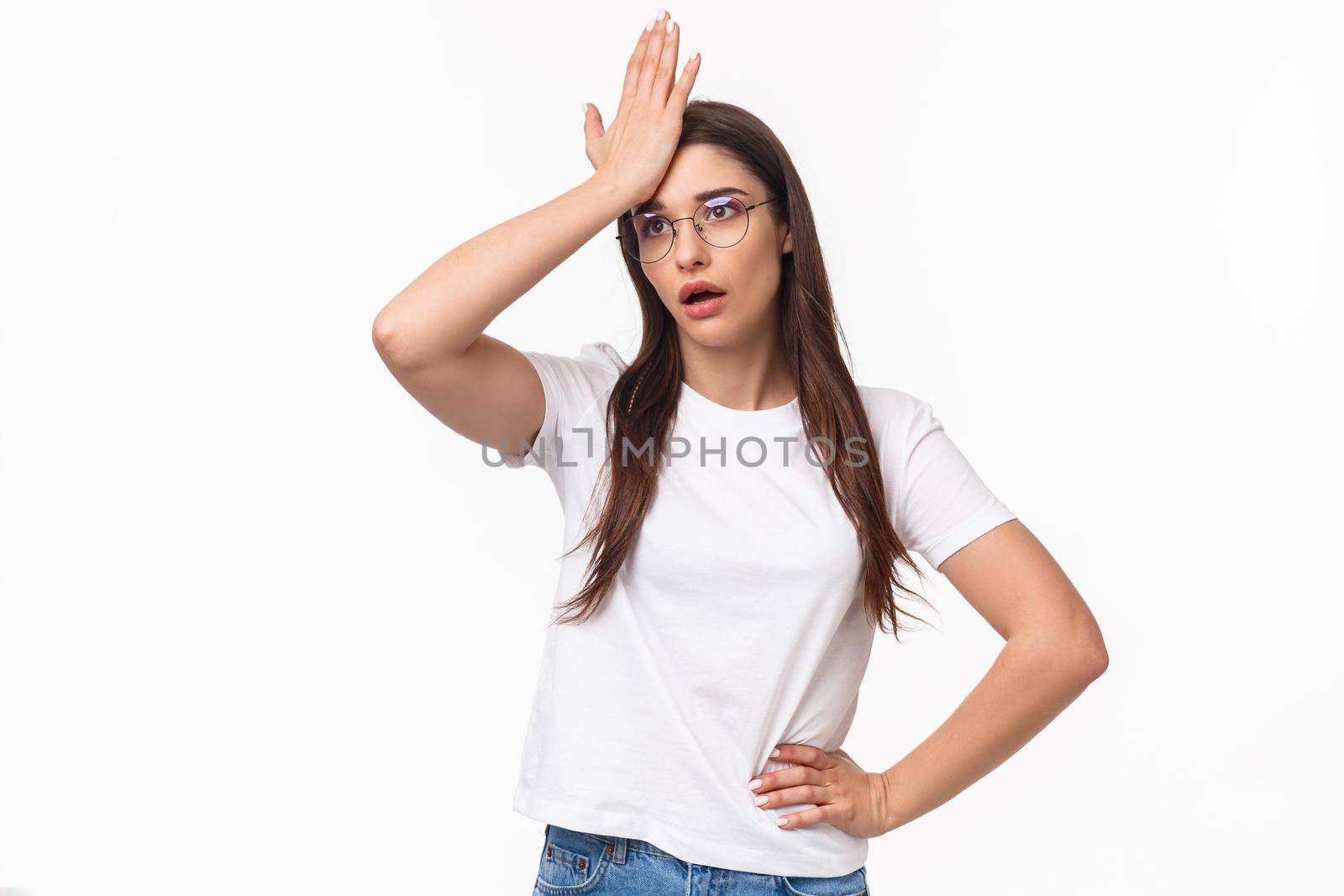 Girl realised she made dumb mistake. Bothered forgetful young caucasian woman punch forehead and sighing, looking gloomy as remember something important she forgot, white background.