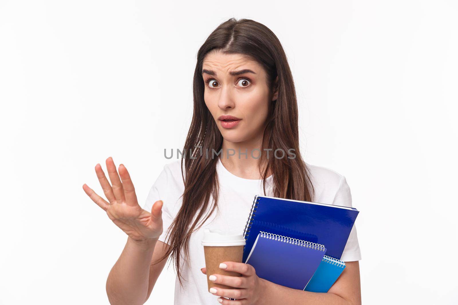 Education, university and studying concept. Wow come down, slow for minute. Close-up portrait of freaked-out shocked young female student saying stop, chill gesture, look concerned hold notebook.