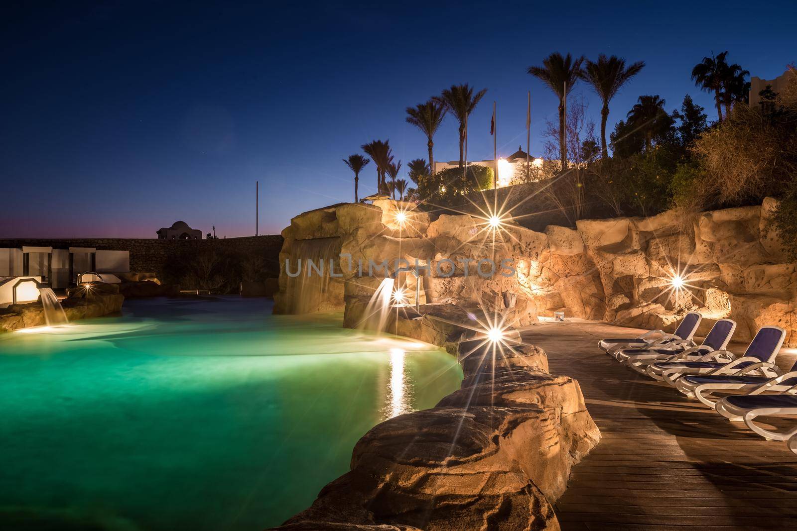 Long exposure shot of a swimming pool at luxury night illumination on a beautiful resort in Egypt