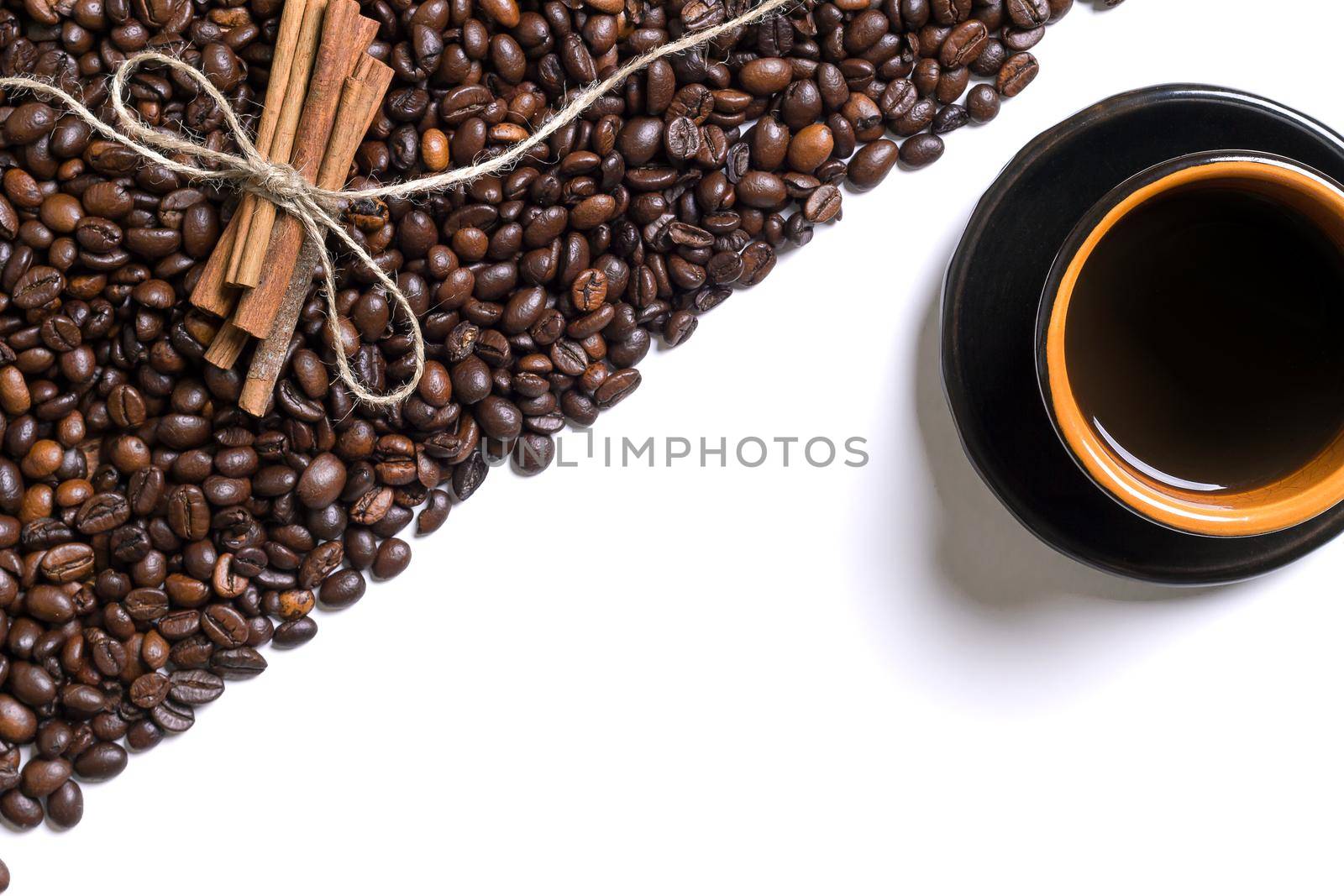 Cup of coffe, grains of coffee and cinnamon on a white background. Top view. Still life. Copy space. Flat lay.