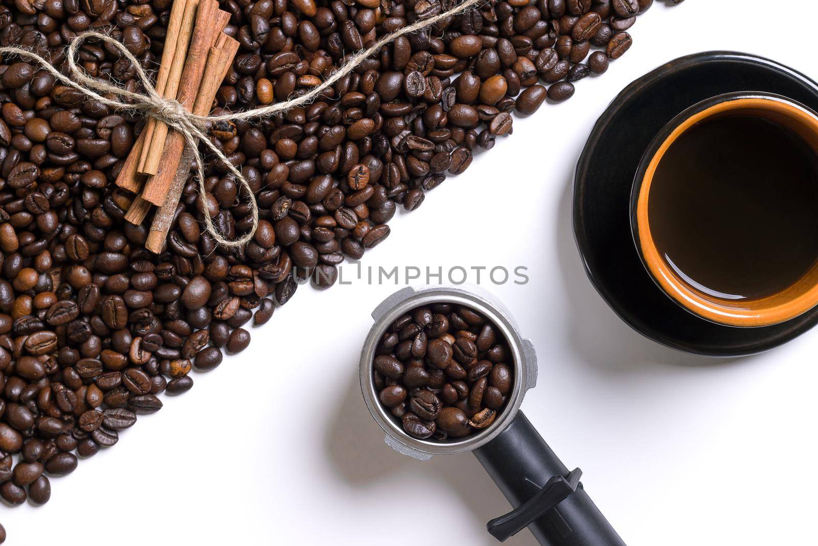 Cup of coffe, grains of coffee and cinnamon on a white background. Top view. Still life. Copy space. Flat lay.
