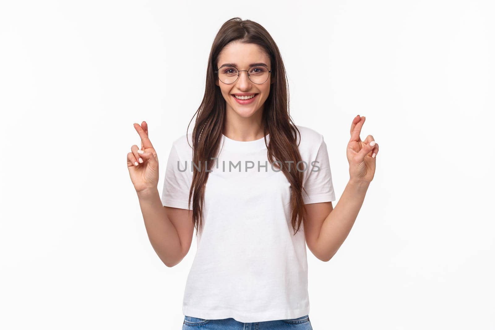 Waist-up portrait of optimistic girl believe dreams do come true, wear glasses and t-shirt, cross fingers good luck, make wish, praying and anticipating positive results, white background.