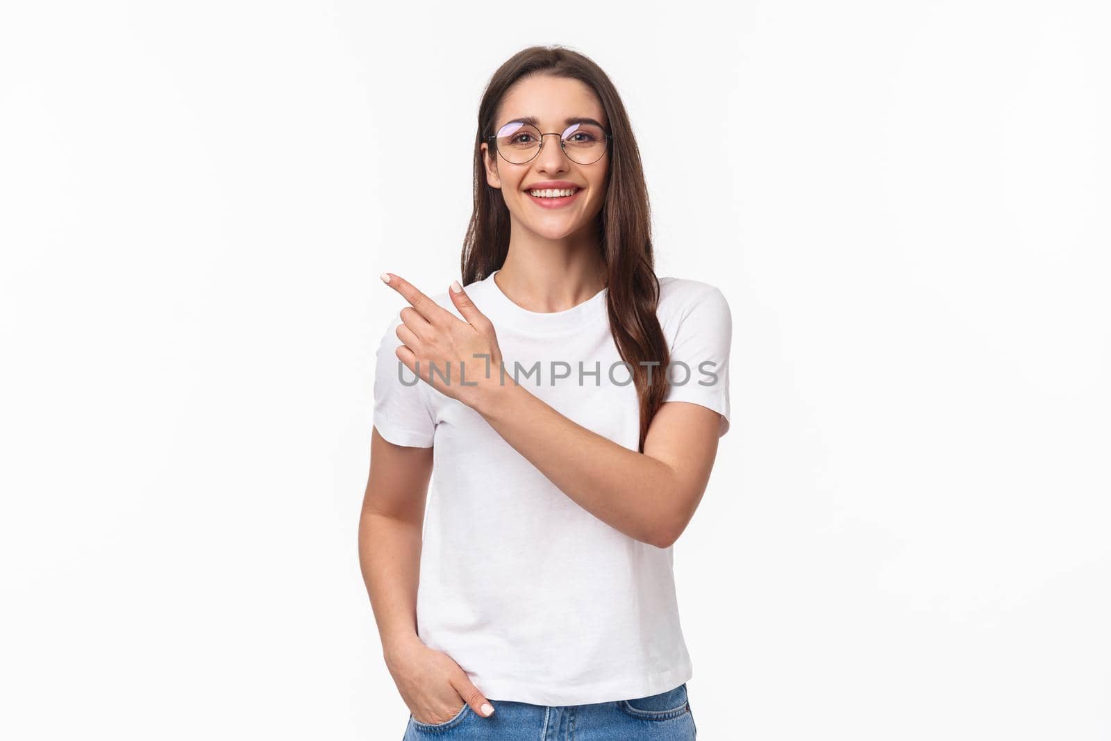 Waist-up portrait of friendly, attractive young 20s woman in glasses, giving advice, recommend try this online shop, click link or visit promo page, pointing finger upper left corner, smile camera.