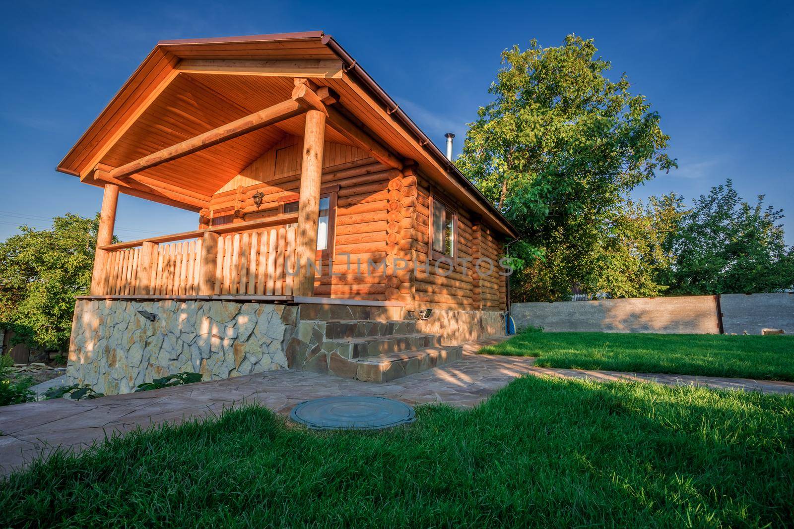 Wooden house with meadow in front of it by nazarovsergey