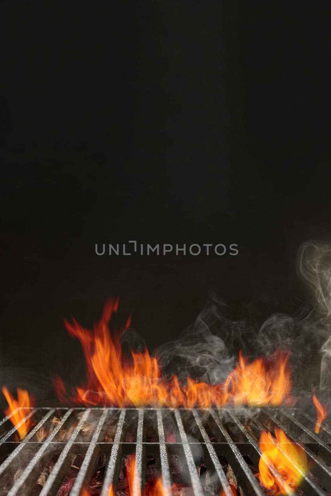 Hot empty portable summer barbecue BBQ grill with bright flaming fire and ember charcoal on black background. Cookout concept. Close up, copy space by nazarovsergey