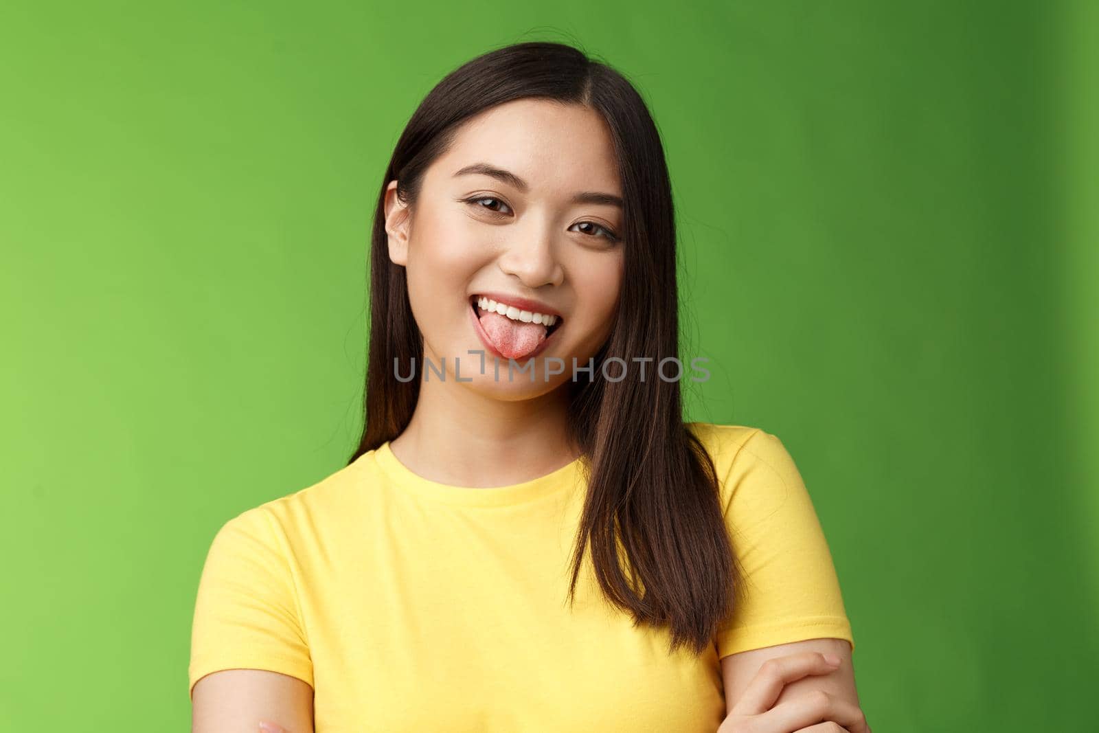 Close-up silly cute flirty asian girl fool around childish, playfully communicate boyfriend, show tongue smiling broadly, cross hands chest casually, enjoy summer holidays, green background by Benzoix