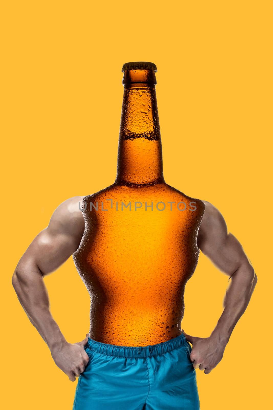 Modern collage. Concept man with bottle beer body and head, muscular arms on yellow background. Art pattern