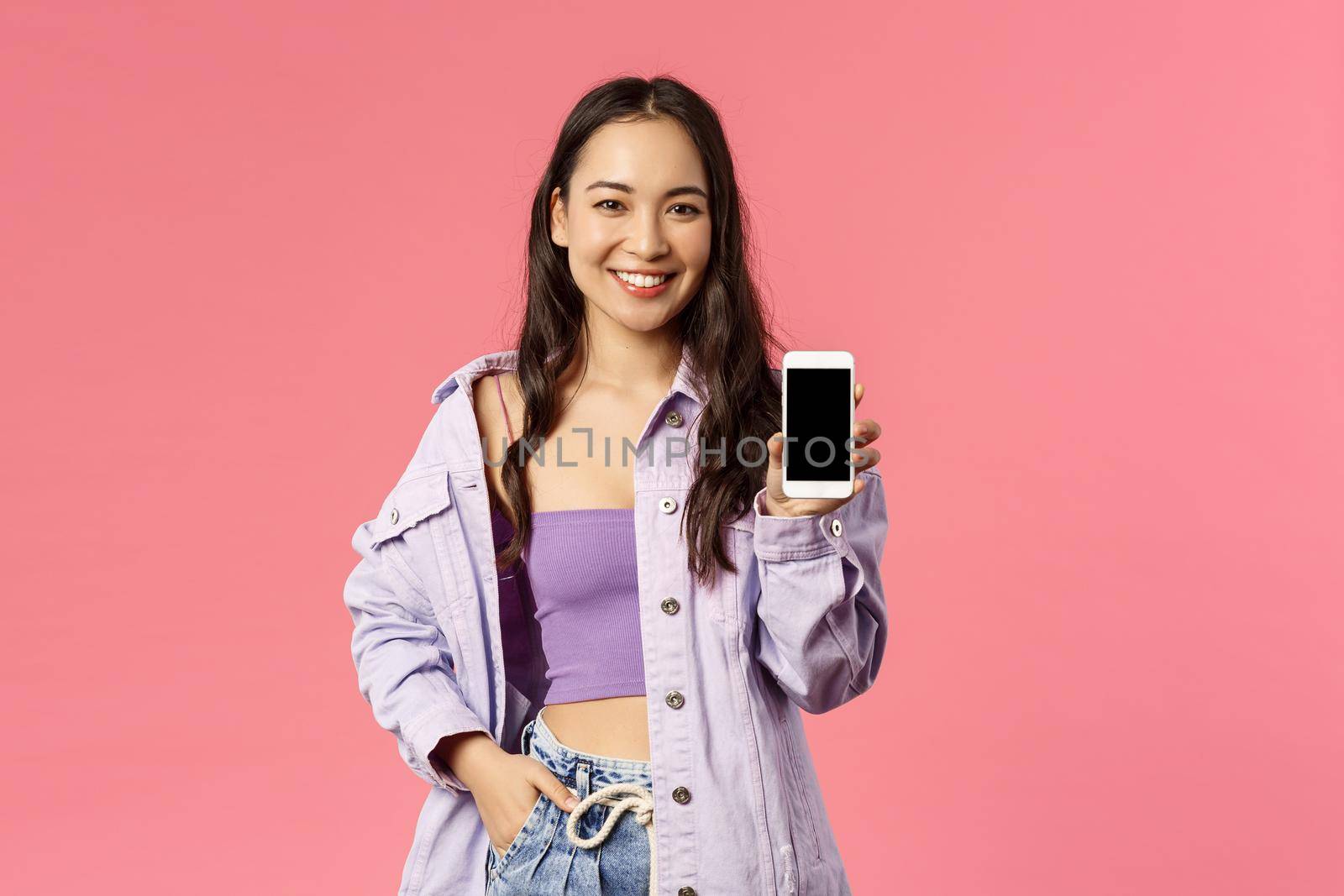 Online lifestyle, people and beauty concept. Portrait of modern stylish hipster girl, korean female showing you mobile phone display, recommend app or internet store on smartphone.
