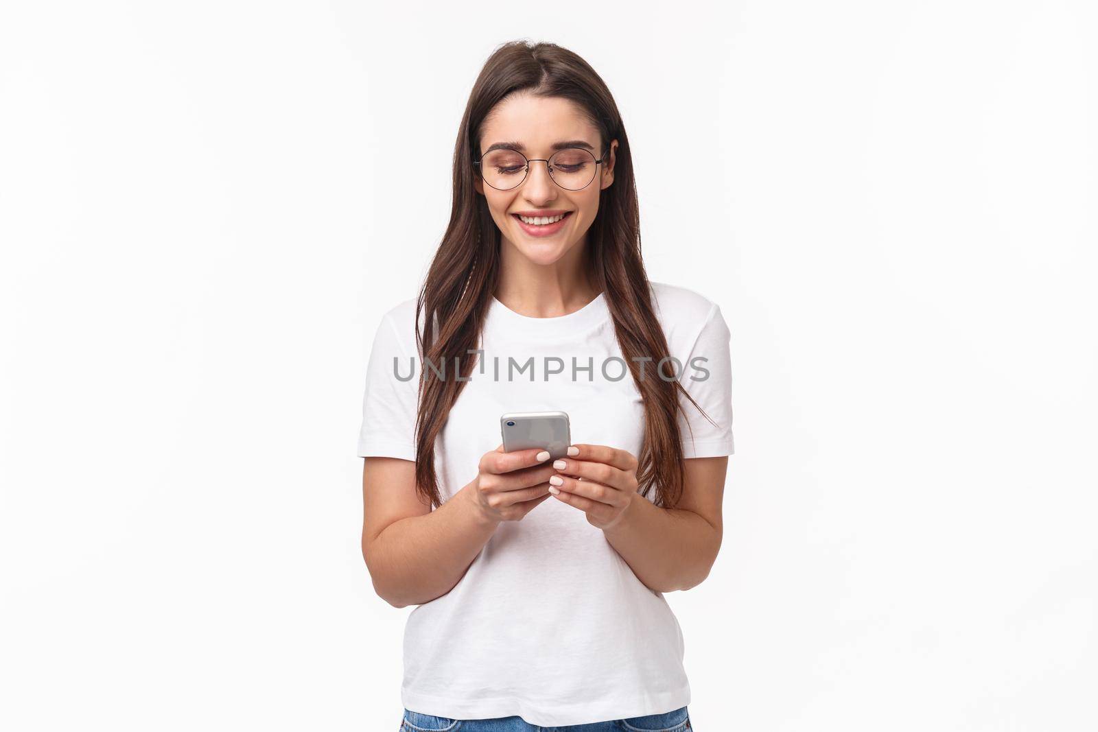 Portrait of charismatic smiling happy woman using mobile phone, holding smarphone chatting with friends while sitting at home, scroll internet feed, use application, smile at display.