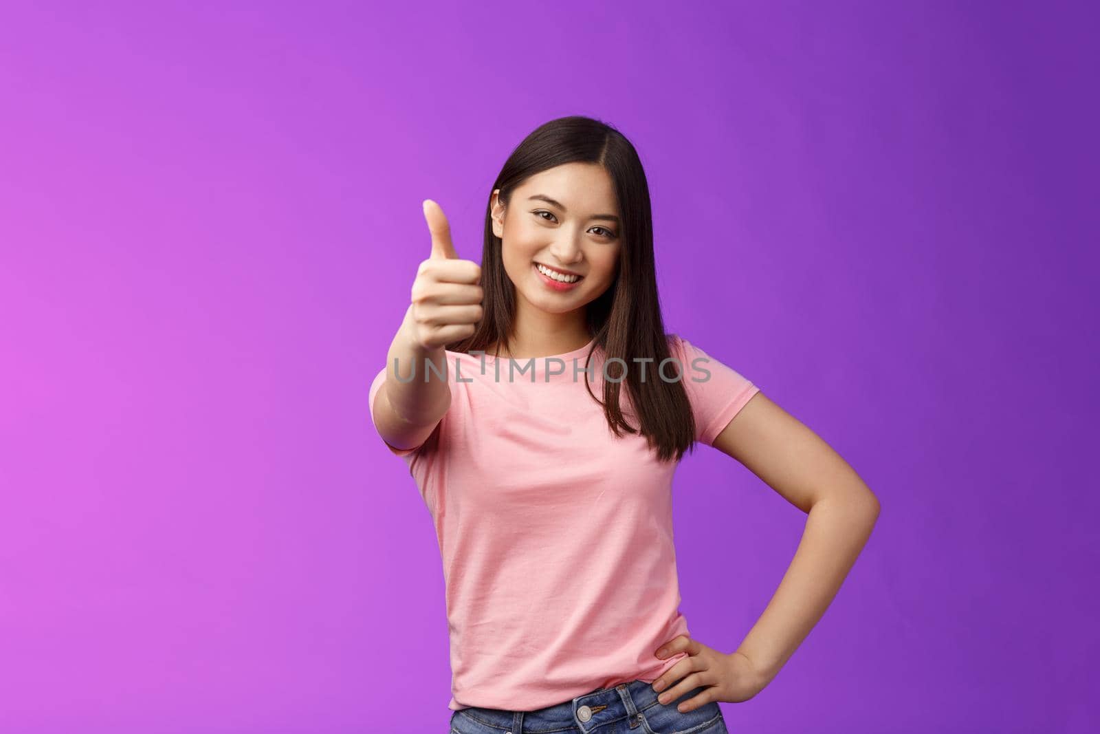 Good choice, well done. Pleased happy asian woman in pink t-shirt show thumb-up, approving like your idea, smiling joyfully, accept plan, agree, recommend product, give positive judgement.