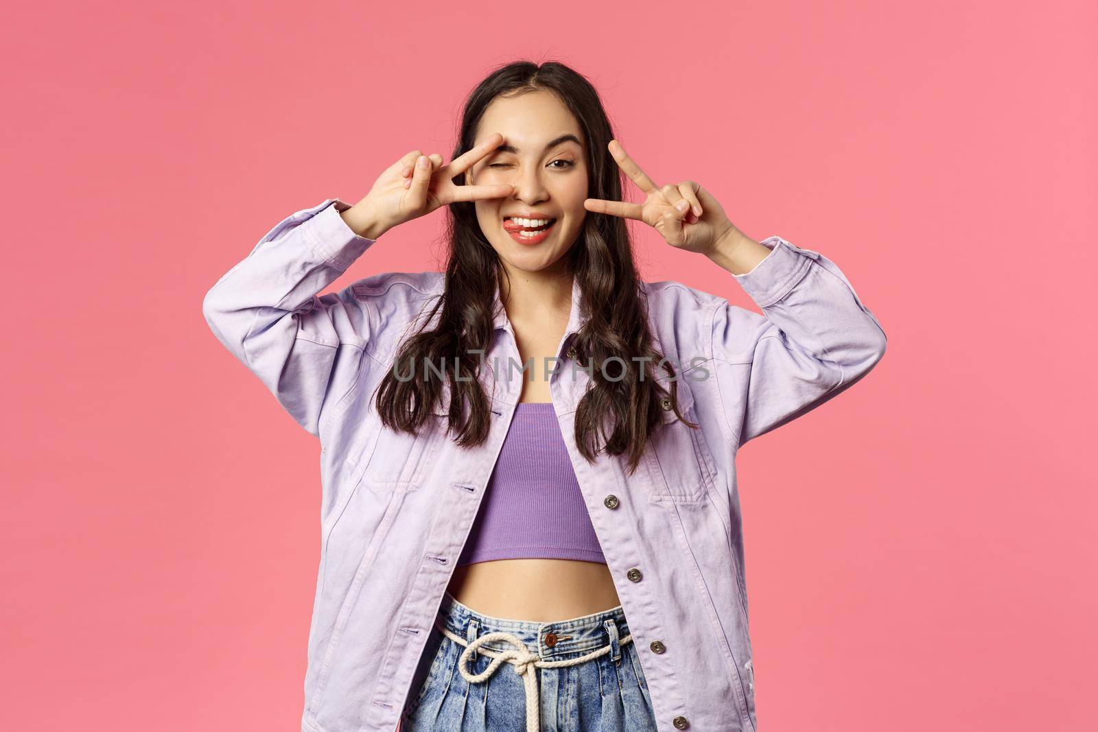 Love and peace people. Cheerful carefree attractive girl sending positivity and happiness, show goodwill kawaii sign and smiling, being in good mood, enjoying end of quarantine, pink background by Benzoix