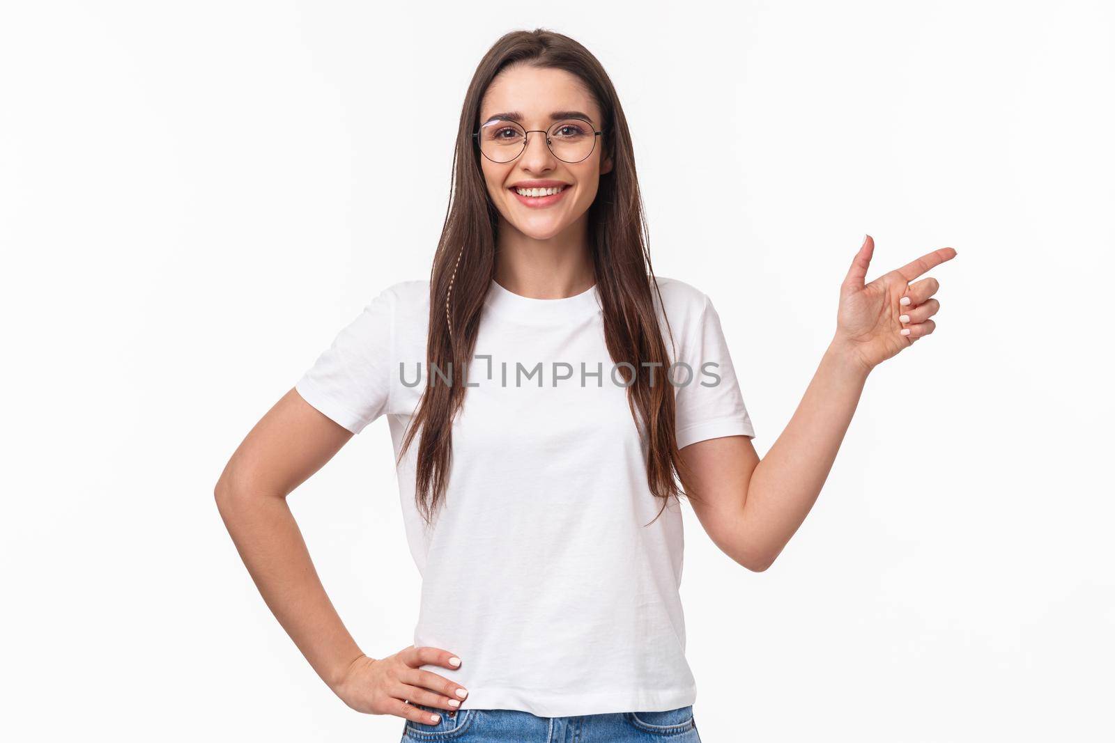 Waist-up portrait of confident smiling, friendly-looking young professional IT programmer female in glasses, inviting people join her company start career after graduation, point right.