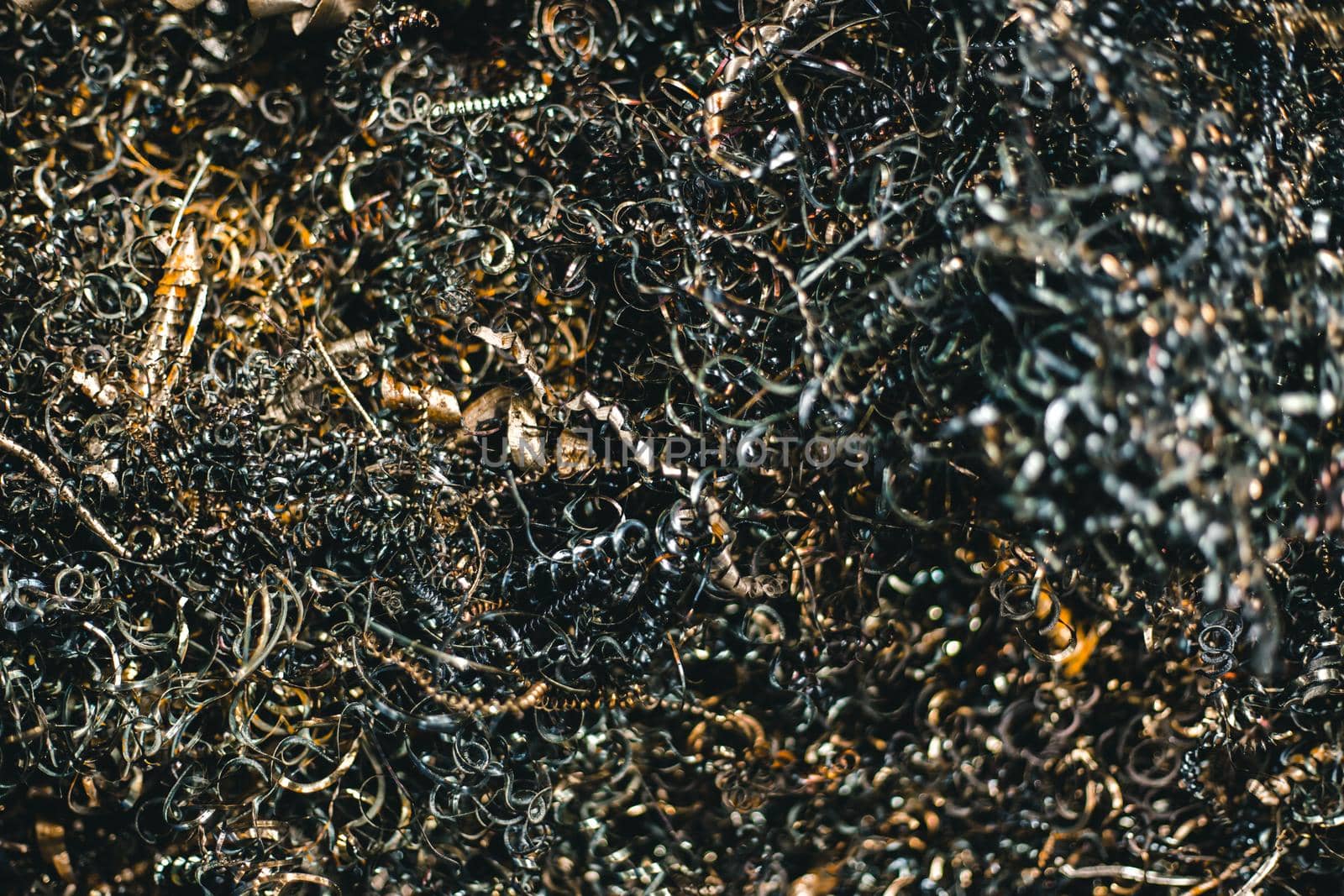 Twisted spiral steel or scrap metal shavings garbage from CNC machine, industrial arts image.
