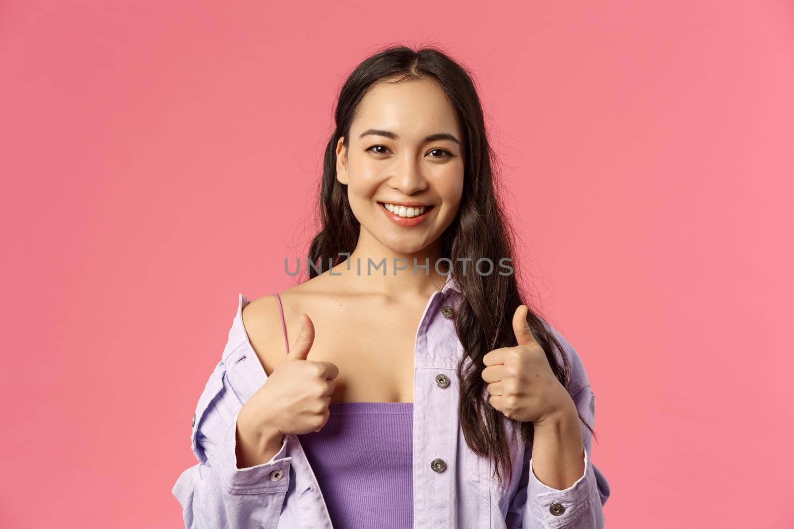 Sounds good Im in. Close-up portrait of satisfied, excited smiling beautiful asian girl in stylish outfit, recommend product, pleased with service or company, show thumbs-up, like and approve.