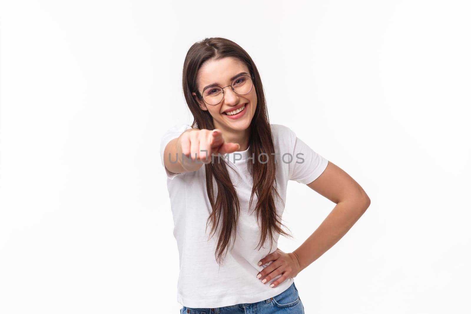 Waist-up portrait of enthusiastic, happy funny young woman 20s in t-shirt and glasses, laughing out loud having fun, pointing finger at camera as joking, choosing someone, make choice.