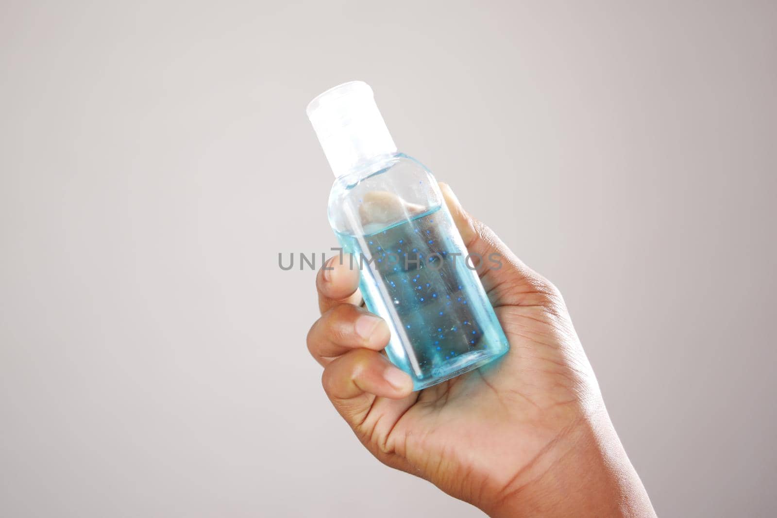close up of young man hand using sanitizer gel for preventing virus.