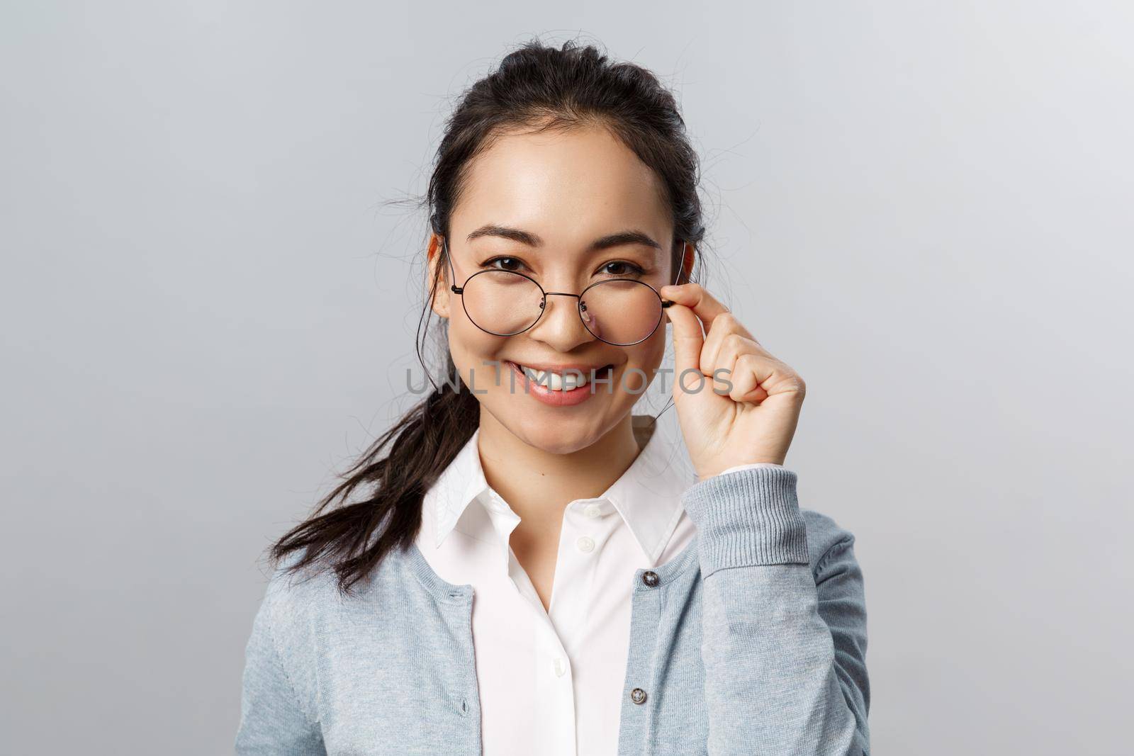 Advertisement, people and emotion concept. Close-up portrait of confident, professional asian brunette female, take-off glasses and look pleased camera, express satisfaction and self-assurance by Benzoix