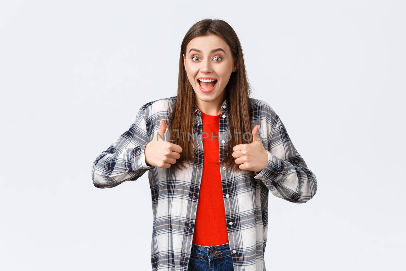 Lifestyle, different emotions, leisure activities concept. Super good idea. Cheerful excited pretty woman in casual checked shirt, thumbs-up and smiling, approving, like idea or support your choice by Benzoix