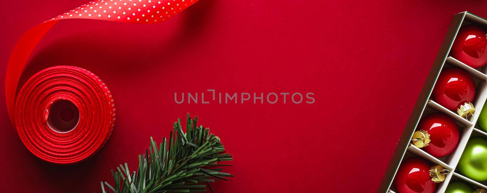 Christmas flatlay and holiday design concept. Decoration, ornament and xmas gift wrapping on red paper background as flat lay top view.