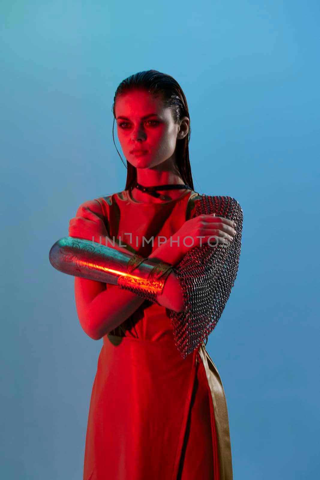 beautiful woman Glamor posing red light metal armor on hand Lifestyle unaltered. High quality photo