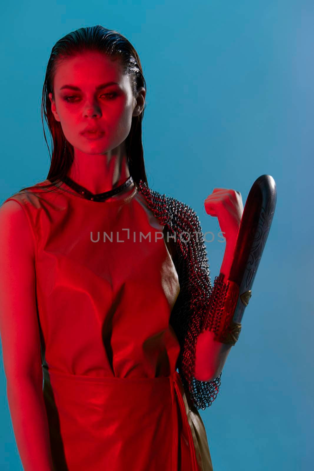 photo pretty woman Glamor posing red light metal armor on hand Lifestyle unaltered. High quality photo